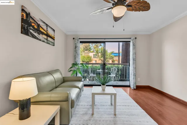 a living room with furniture and a dining table