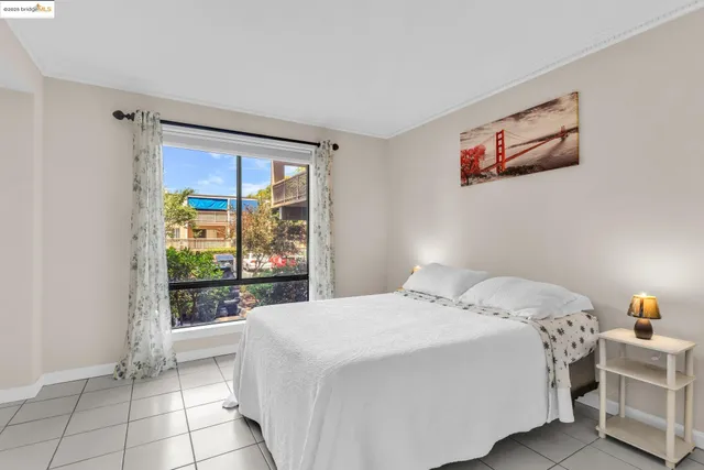 a bedroom with a bed and a view of kitchen