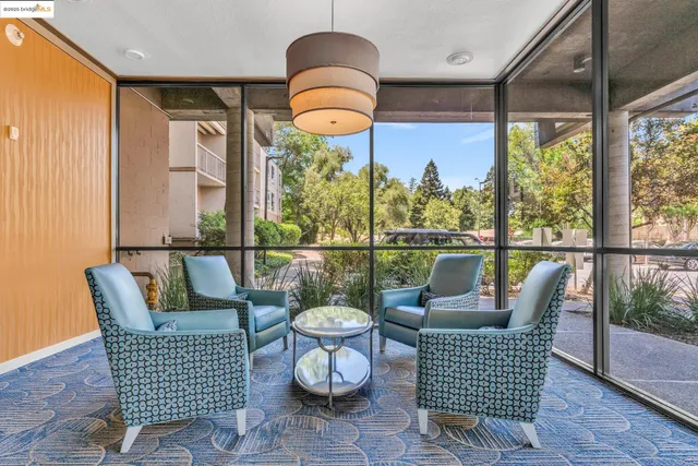 a balcony view with a seating space and a potted plant
