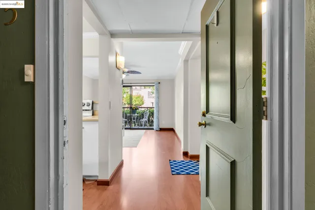 a view of a hallway with wooden floor fireplace and living room