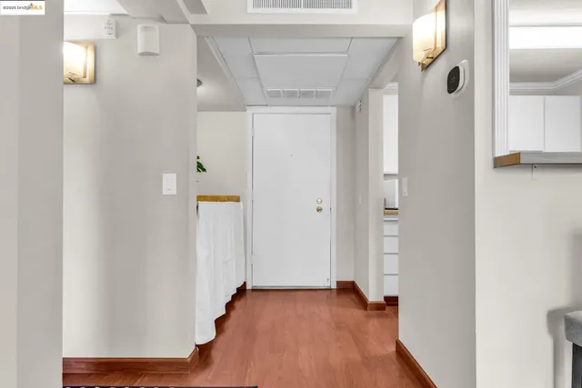 a view of a hallway with wooden floor