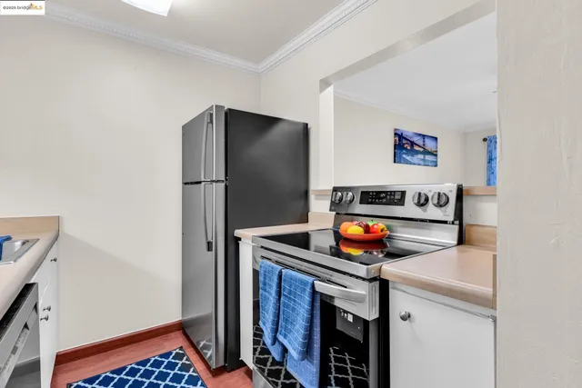 a kitchen with stainless steel appliances a refrigerator and a stove