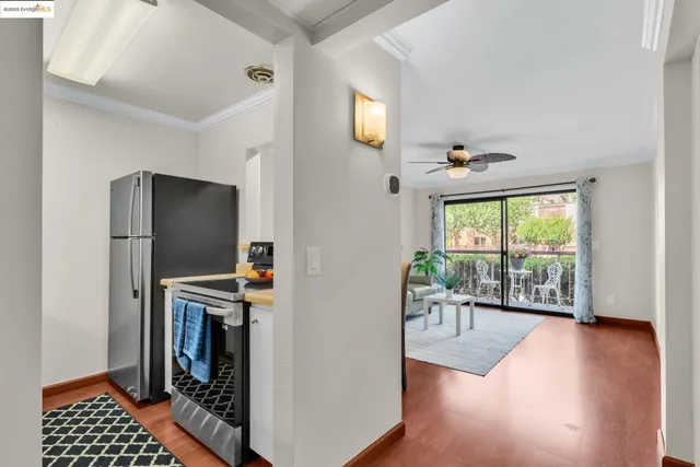 a very nice looking living room with a large window and stainless steel appliances