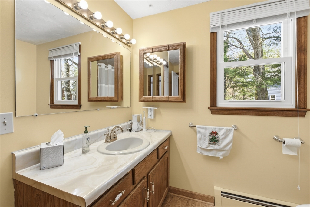 19 Mockingbird Lane Maynard, MA 01754 - Photo 23 of 34 a bathroom with a sink vanity and a mirror