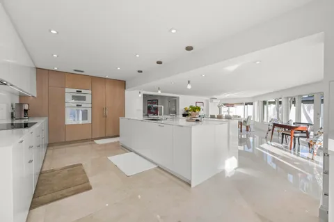 a view of kitchen with furniture and refrigerator