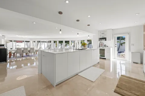 a kitchen with stainless steel appliances kitchen island granite countertop a refrigerator and cabinets