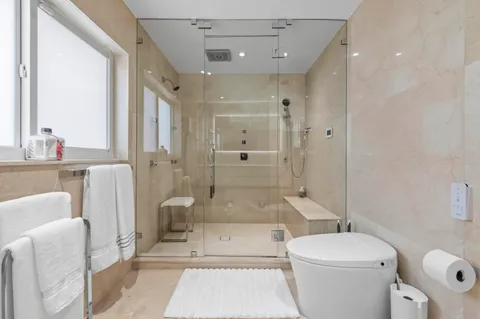 a bathroom with a tub a toilet and a shower