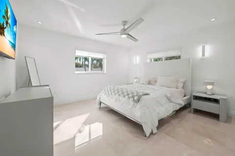 a bedroom with a large bed and a chandelier