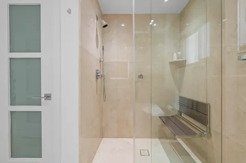 a bathroom with a shower and a sink