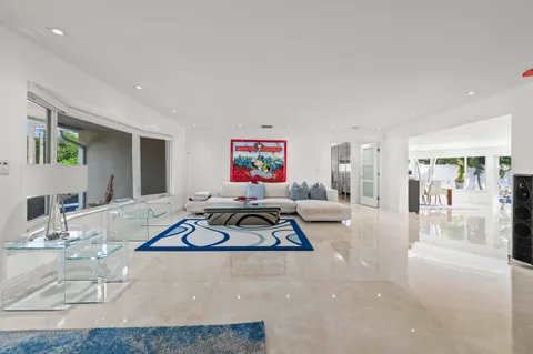 a living room with furniture a flat screen tv and a table