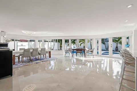 a view of a dining hall with couches and dining table chairs