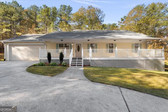 a view of a house with a swimming pool and a yard