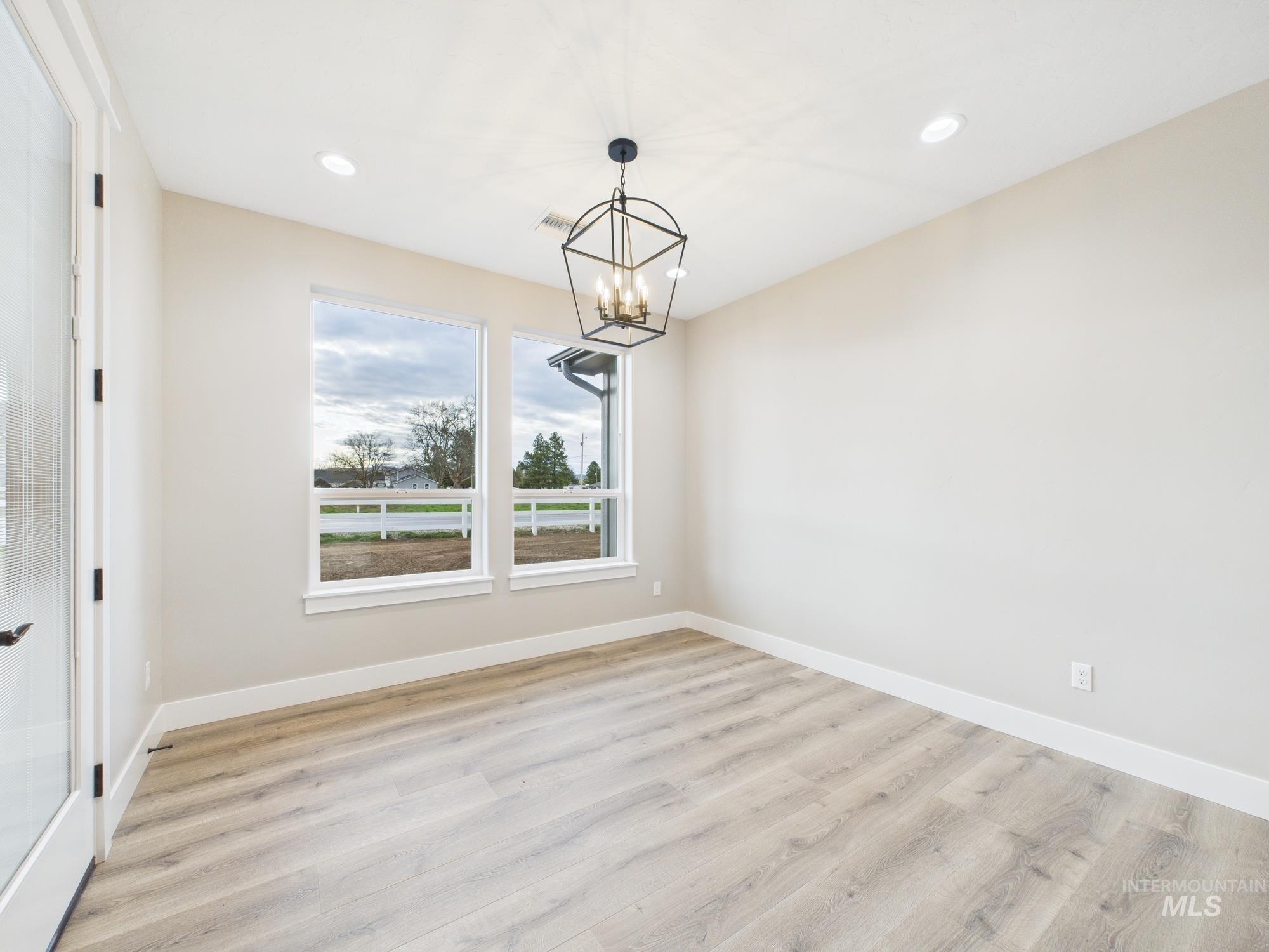 1910 Ruth Lane Emmett, ID 83617 - Photo 12 of 42 Unfurnished dining area featuring light wood finished floors, recessed lighting, and a chandelier