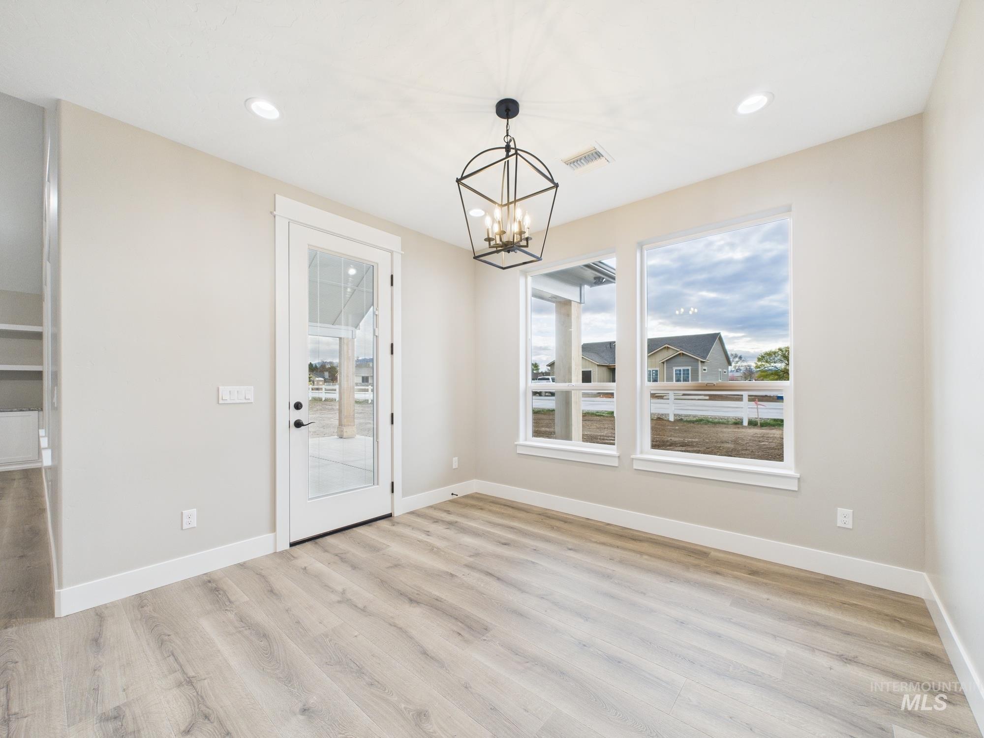 1910 Ruth Lane Emmett, ID 83617 - Photo 13 of 42 Unfurnished dining area featuring light wood finished floors, a chandelier, and recessed lighting