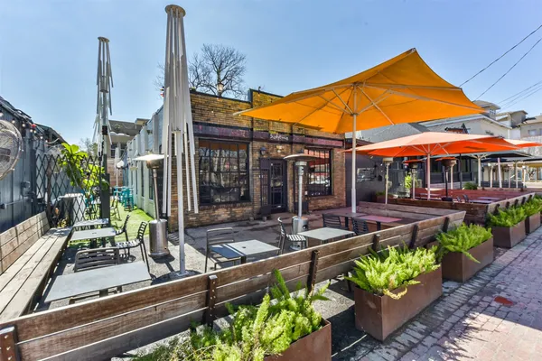 a view of a chairs and table in patio with a fire pit