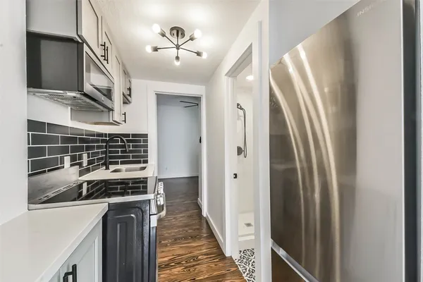 a kitchen with stainless steel appliances a refrigerator and a stove
