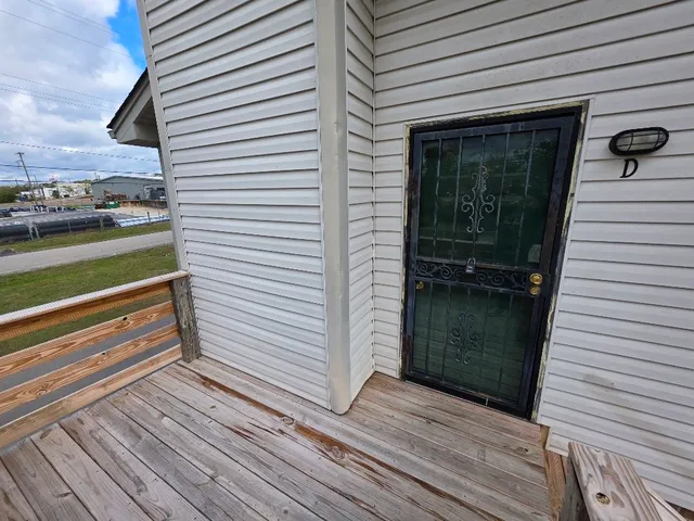 a view of a balcony with a door and wooden floor