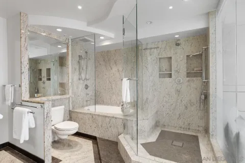 a bathroom with a shower a toilet and a sink