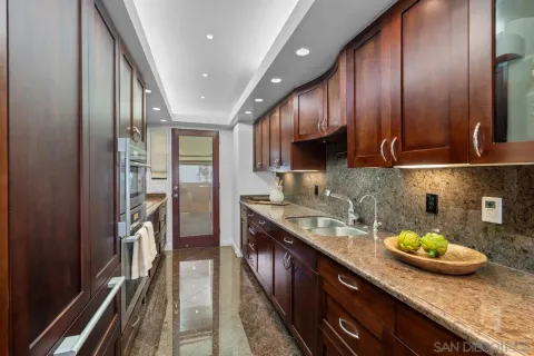 a kitchen with sink cabinets and chandelier