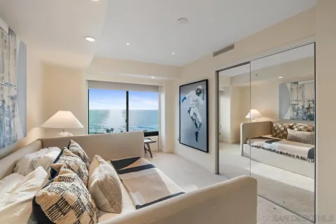 a bedroom with a bed and a large mirror