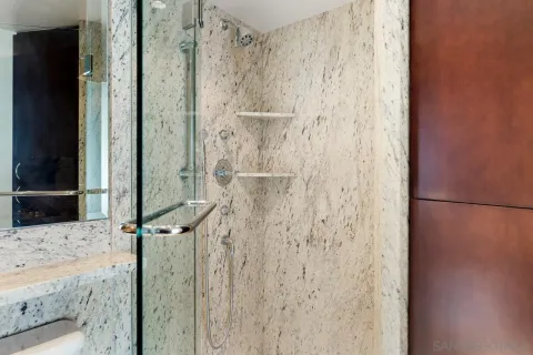 a bathroom with a shower and a sink