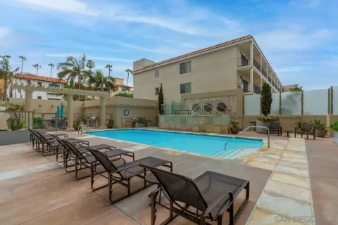 a view of a patio with table and chairs with potted plants and wooden fence