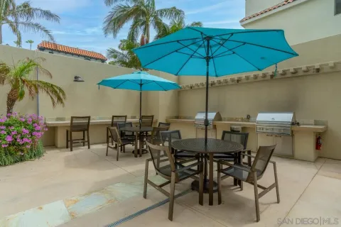 a view of an outdoor space with furniture and umbrella