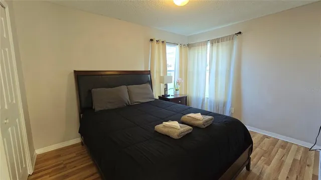 a bed sitting in a bedroom next to a window