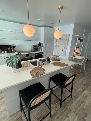a kitchen with a table and chairs in it
