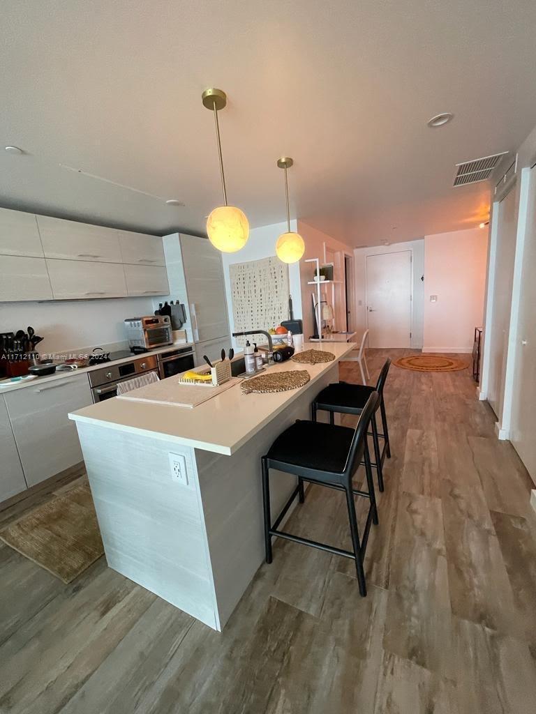 650 Northeast 32nd Street, Unit 3606 Miami, FL 33137 - Photo 20 of 20 a room with table chairs a sink and dishwasher