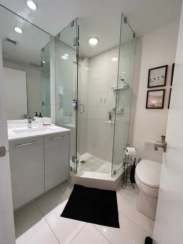 a bathroom with a sink toilet a mirror and vanity