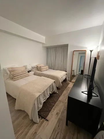 a bedroom with double bed and a night stand