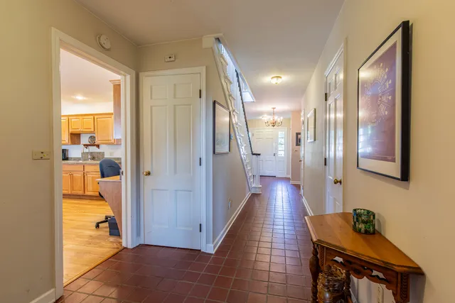 a living room with furniture a ceiling fan and a large window