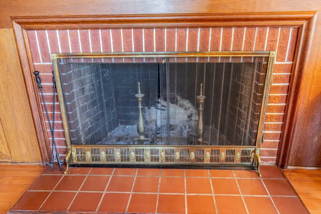 a living room with furniture a fireplace and wooden floor