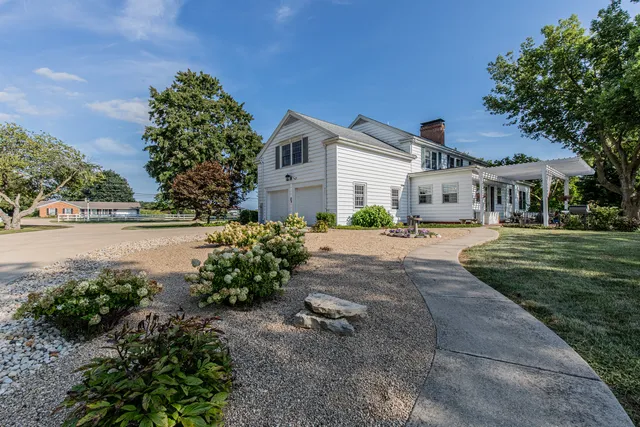 a backyard of a house with yard and outdoor seating