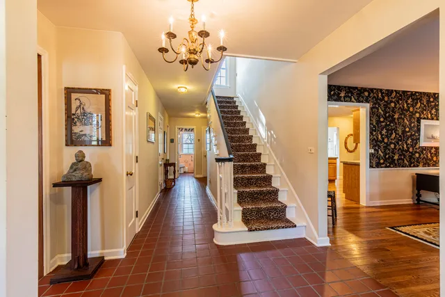 a view of a hallway with wooden floor and staircase