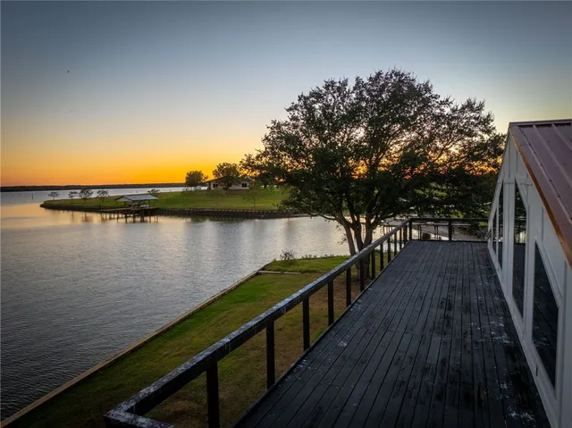 a living room with furniture a flat screen tv and a large window