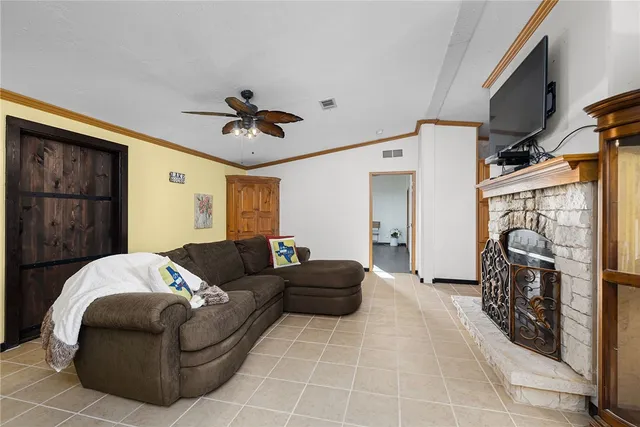 a bedroom with a bed and dresser with wooden floor