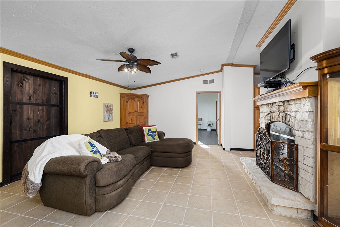 1761 Lcr 822 Groesbeck, TX 76642 - Photo 18 of 93 a living room with furniture a fireplace and a flat screen tv