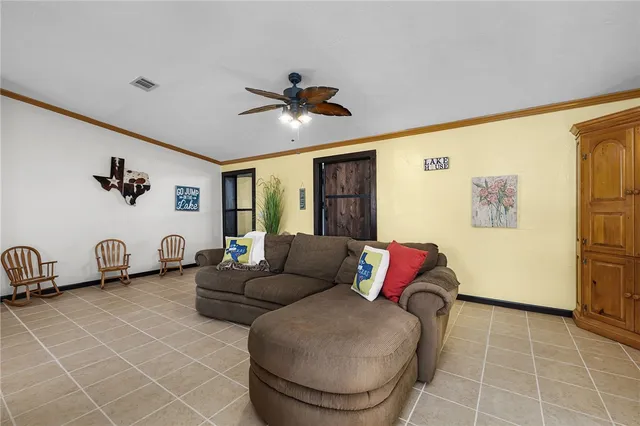 a spacious bedroom with a bed and dresser with wooden floor