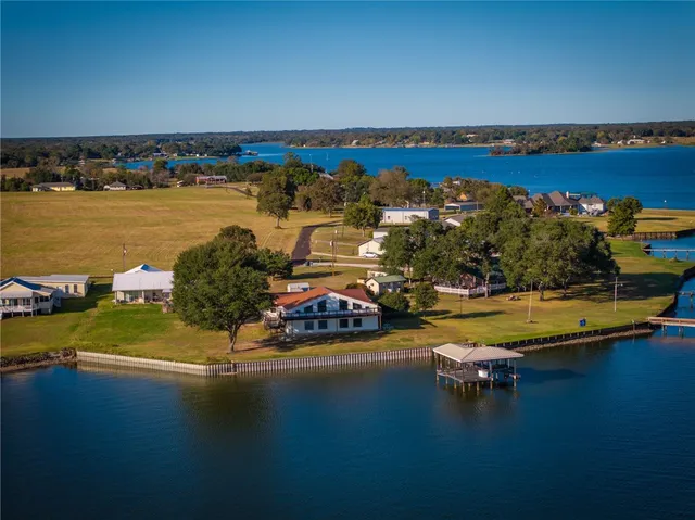 an aerial view of a house with a lake view