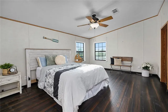 a bedroom with a bed and wooden floor