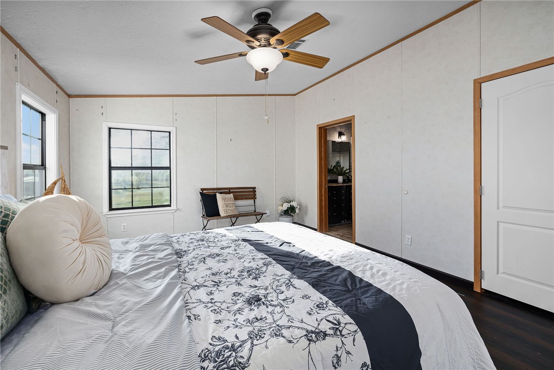 1761 Lcr 822 Groesbeck, TX 76642 - Photo 29 of 93 a spacious bedroom with a bed and dresser with wooden floor