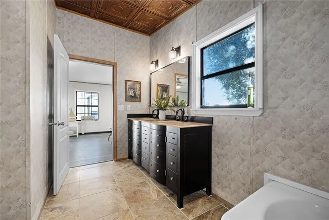 an aerial view of ocean and residential houses with outdoor space