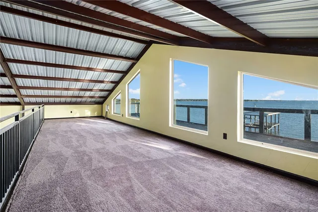 a view of a chairs and table on the roof deck
