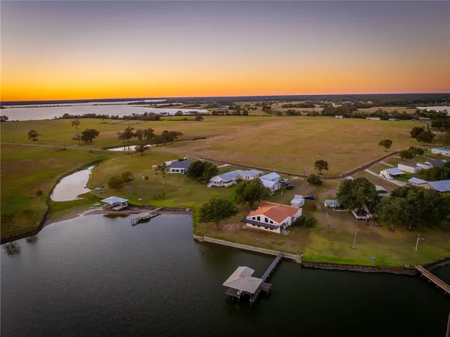 a view of a backyard with plants and outdoor seating