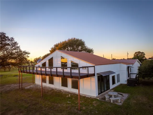 a view of a house with swimming pool and sitting area
