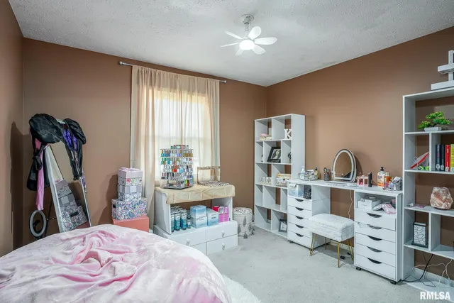 a bed room with a bed and a desk