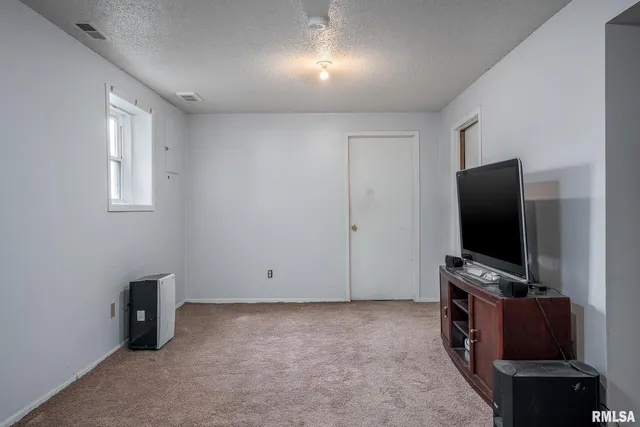 a room with furniture and flat screen tv