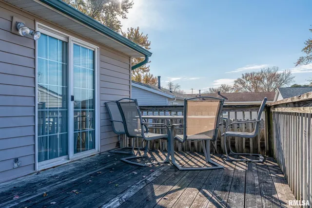a view of a deck with table and chairs and wooden floor